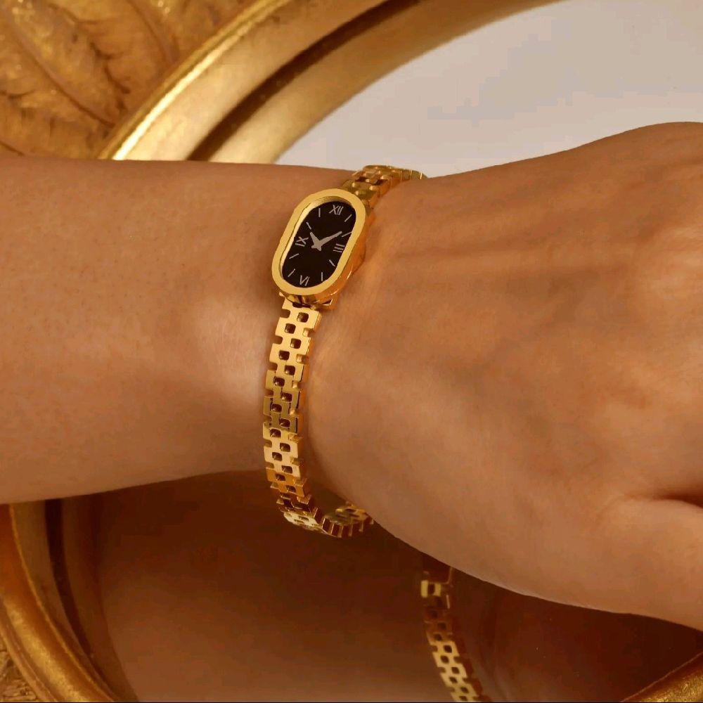 Luxury Gold Women's Watch with Sleek Black Oval Dial Elegant Roman Numerals and Gold Bracelet
