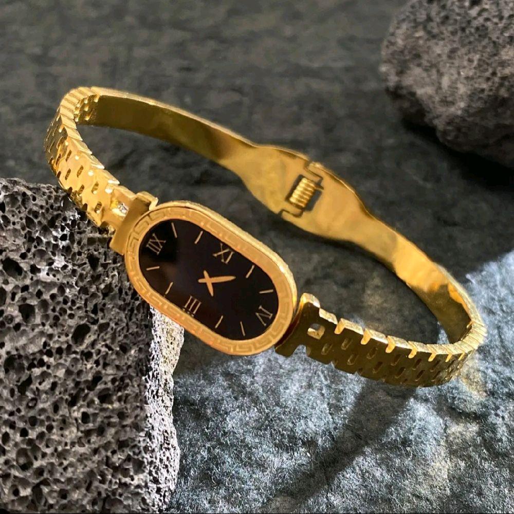 Luxury Gold Women's Watch with Sleek Black Oval Dial Elegant Roman Numerals and Gold Bracelet